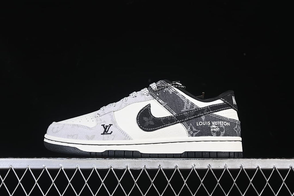 Side view of a white and gray low-top sneaker with dark patterned overlays and a black outsole