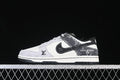 Side view of a white and gray low-top sneaker with dark patterned overlays and a black outsole