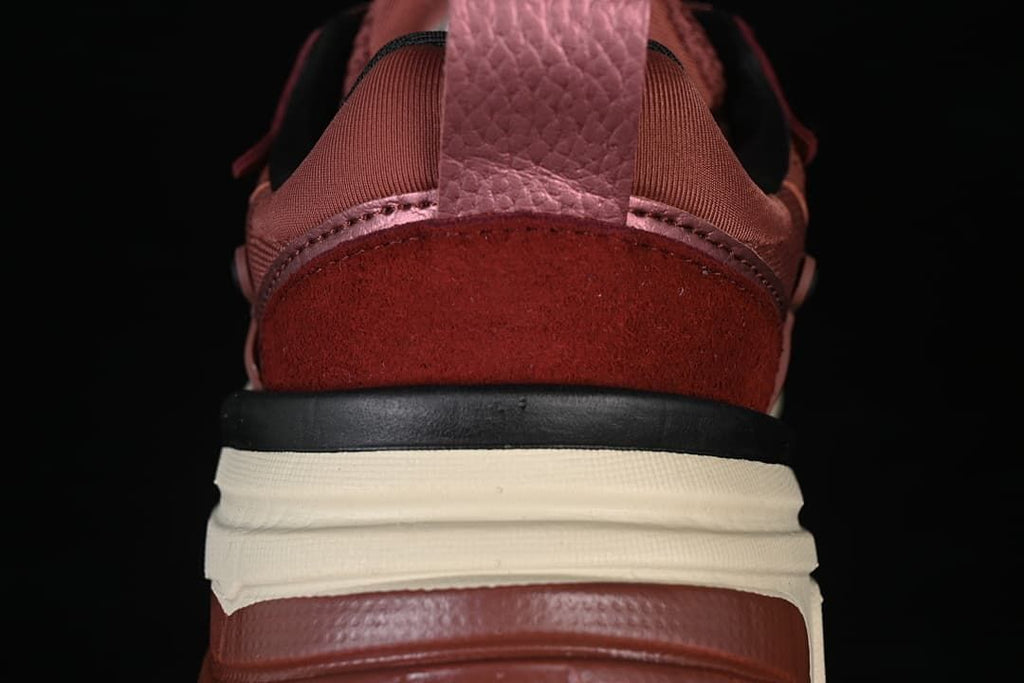 Rear close-up of burgundy sneakers with layered heel and midsole details