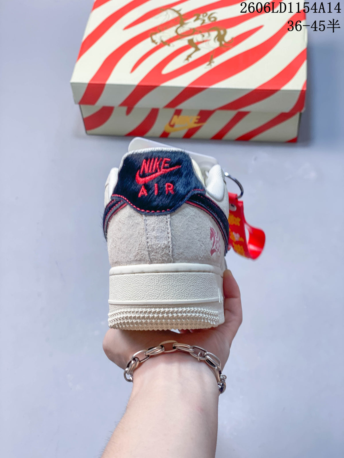 Rear view of a cream low-top sneaker with a navy and red heel tab