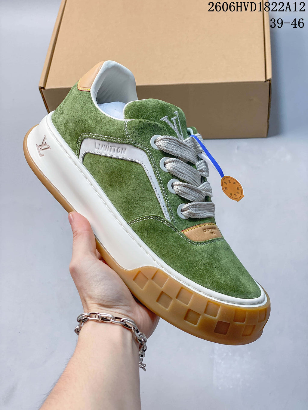 Angled view of the green sneaker showing its white side panel, wide laces, and thick sole