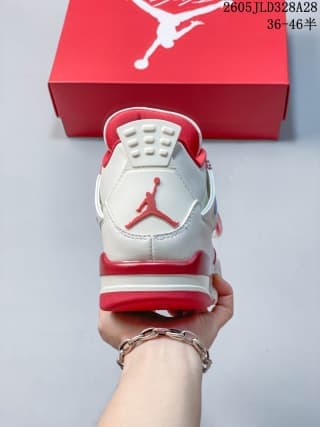 Rear view of a white and red Air Jordan 4 sneaker beside a red shoe box