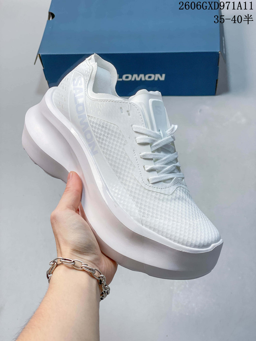 Angled side view of a white Salomon sneaker with a textured upper