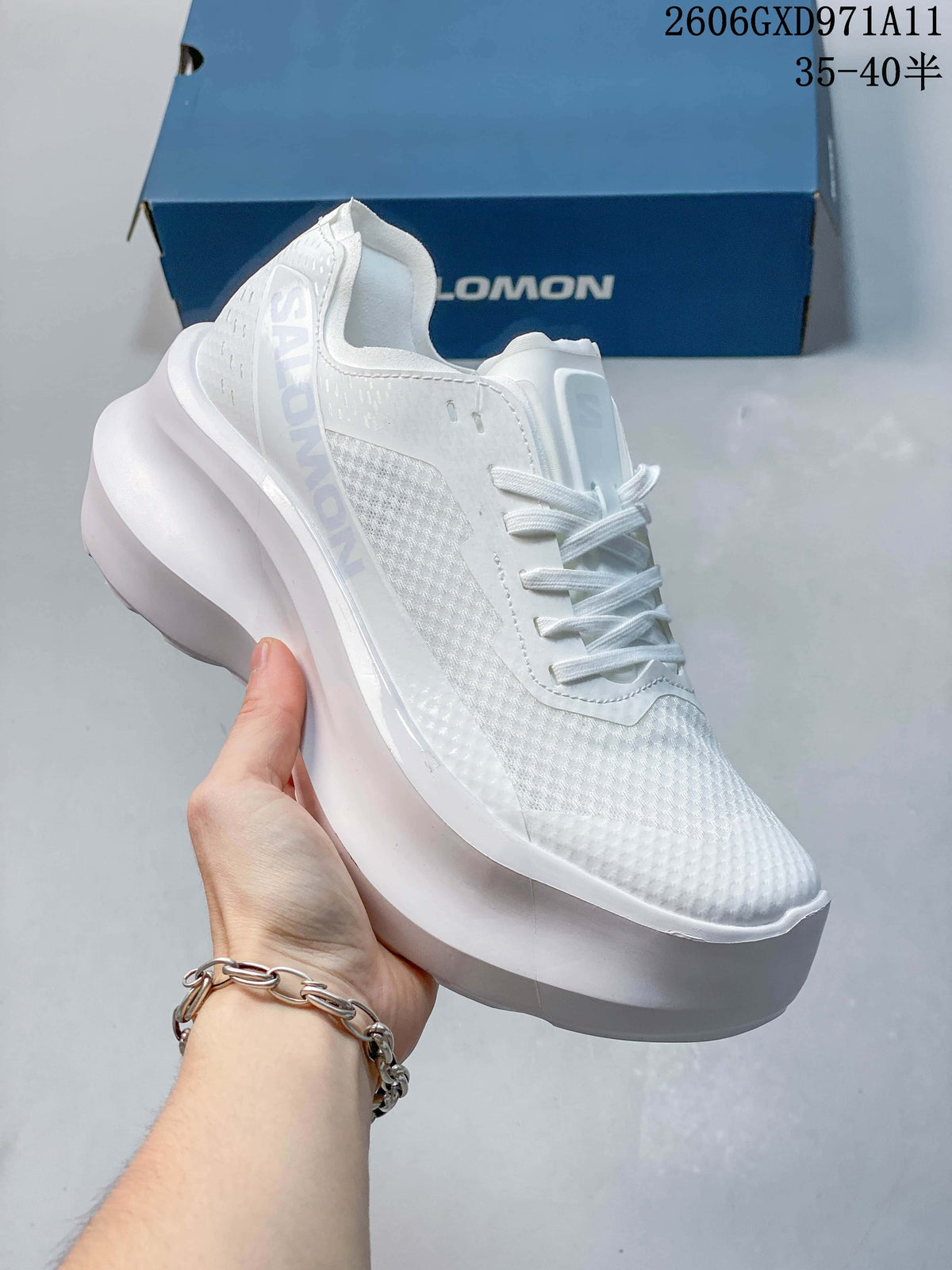 Angled side view of a white Salomon sneaker with a textured upper