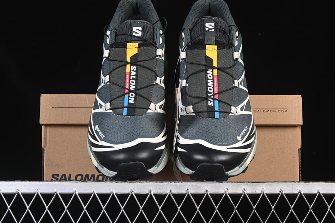 Front view of a pair of Salomon XT-6 GTX sneakers on a shoebox.