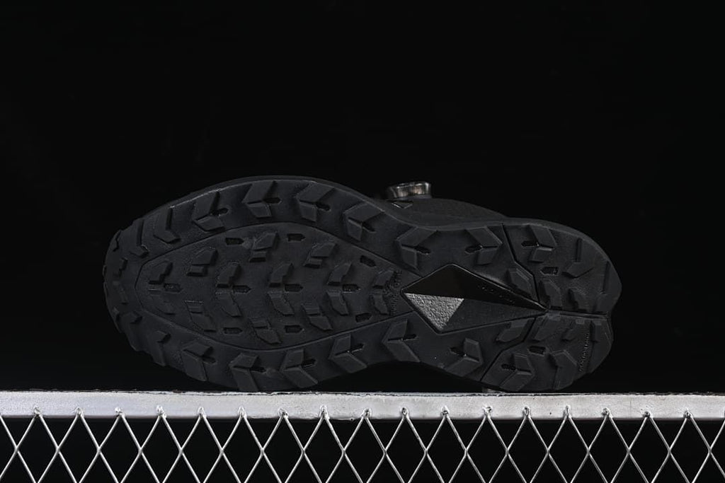 Underside view showing the trail-style outsole lugs.