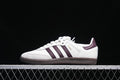 Side view of white adidas Samba OG EMMI sneakers with burgundy stripes and dark outsole