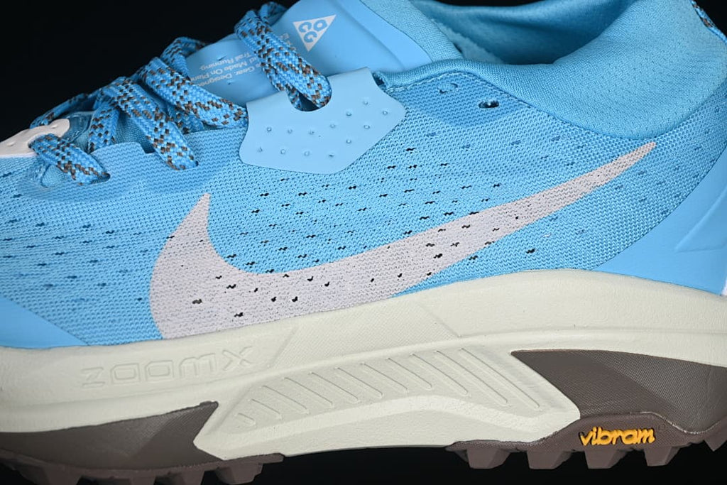 Close-up of the blue upper, Swoosh, midsole and lugged outsole.