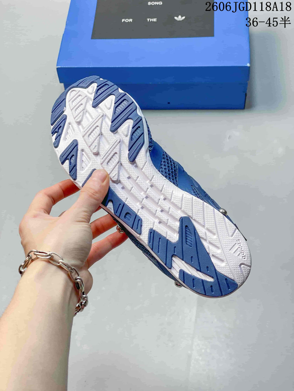 Underside view of the blue and white sneaker outsole.