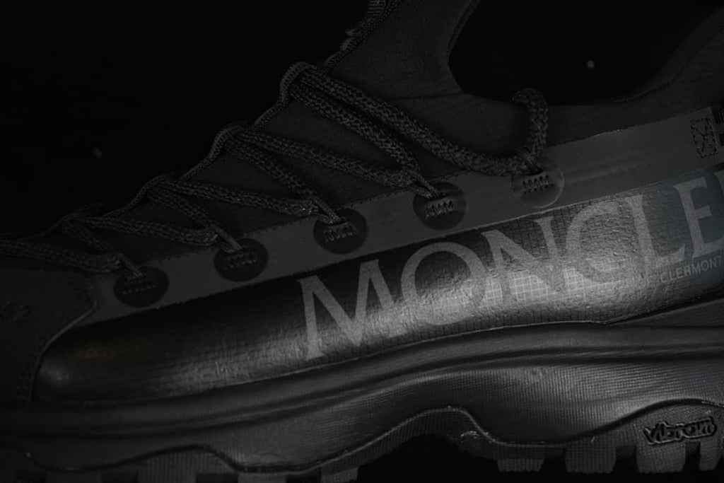 Close-up of the side branding, lace guides and lugged outsole