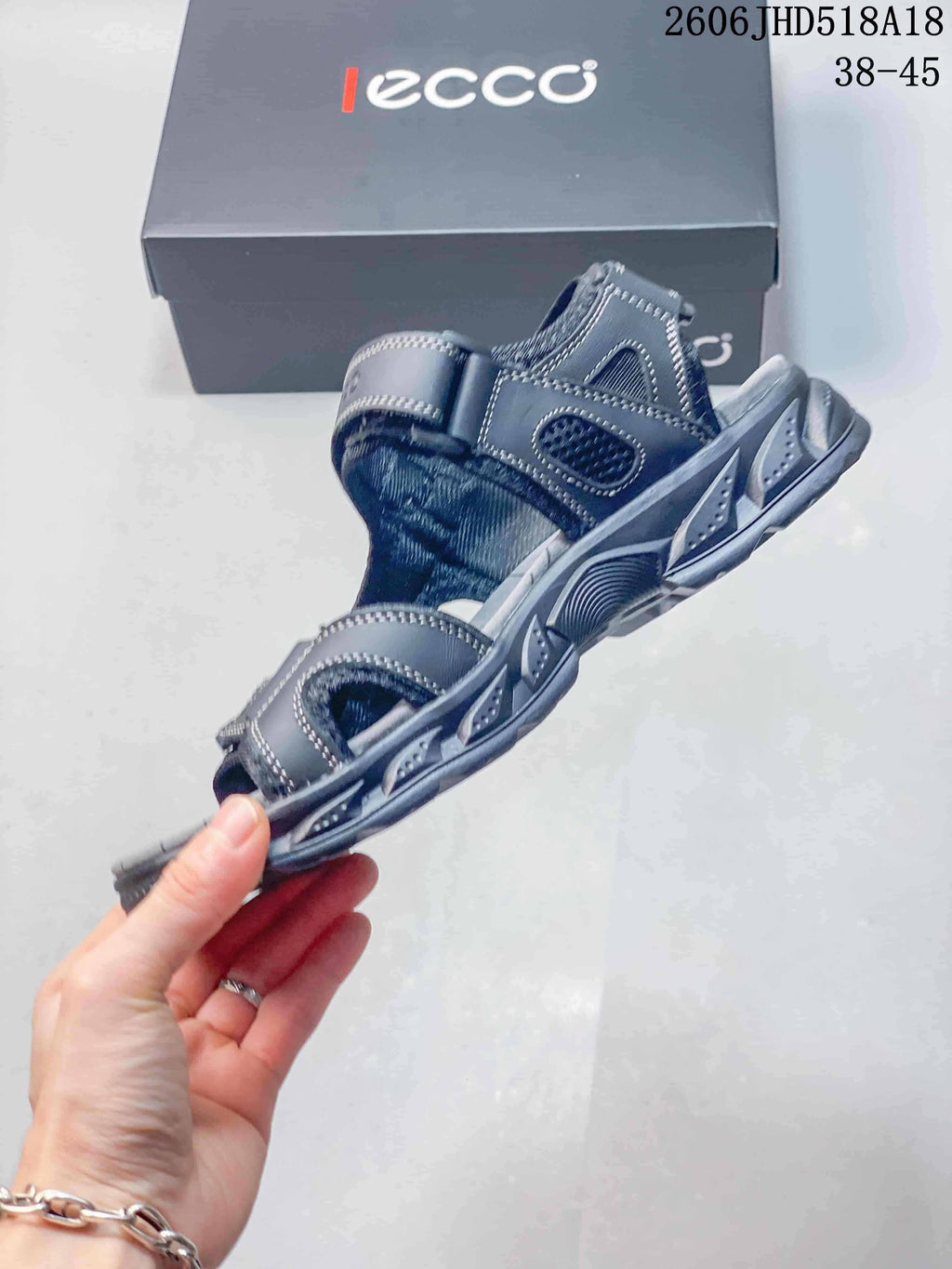 Side view of the gray sandal with layered outsole detailing