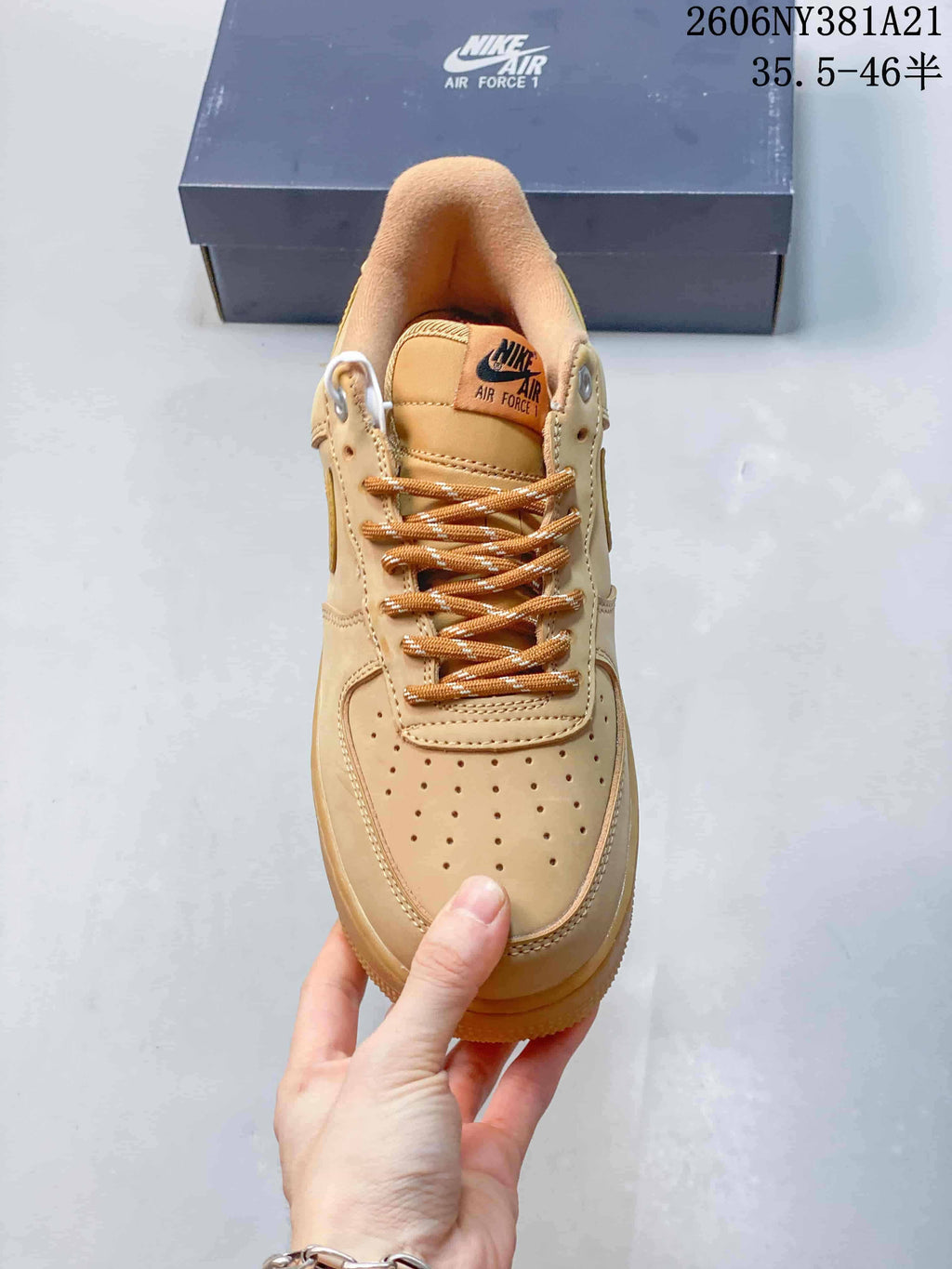Front view of the tan sneaker showing its perforated toe box and patterned laces