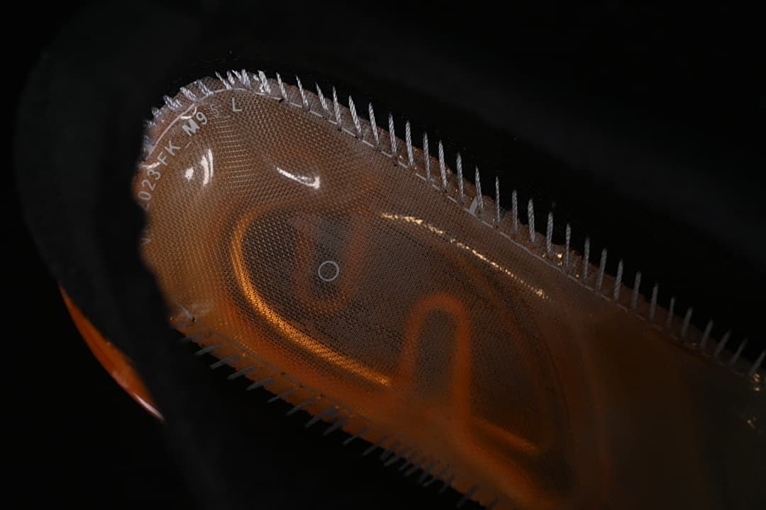 Close-up of the orange transparent heel sole.