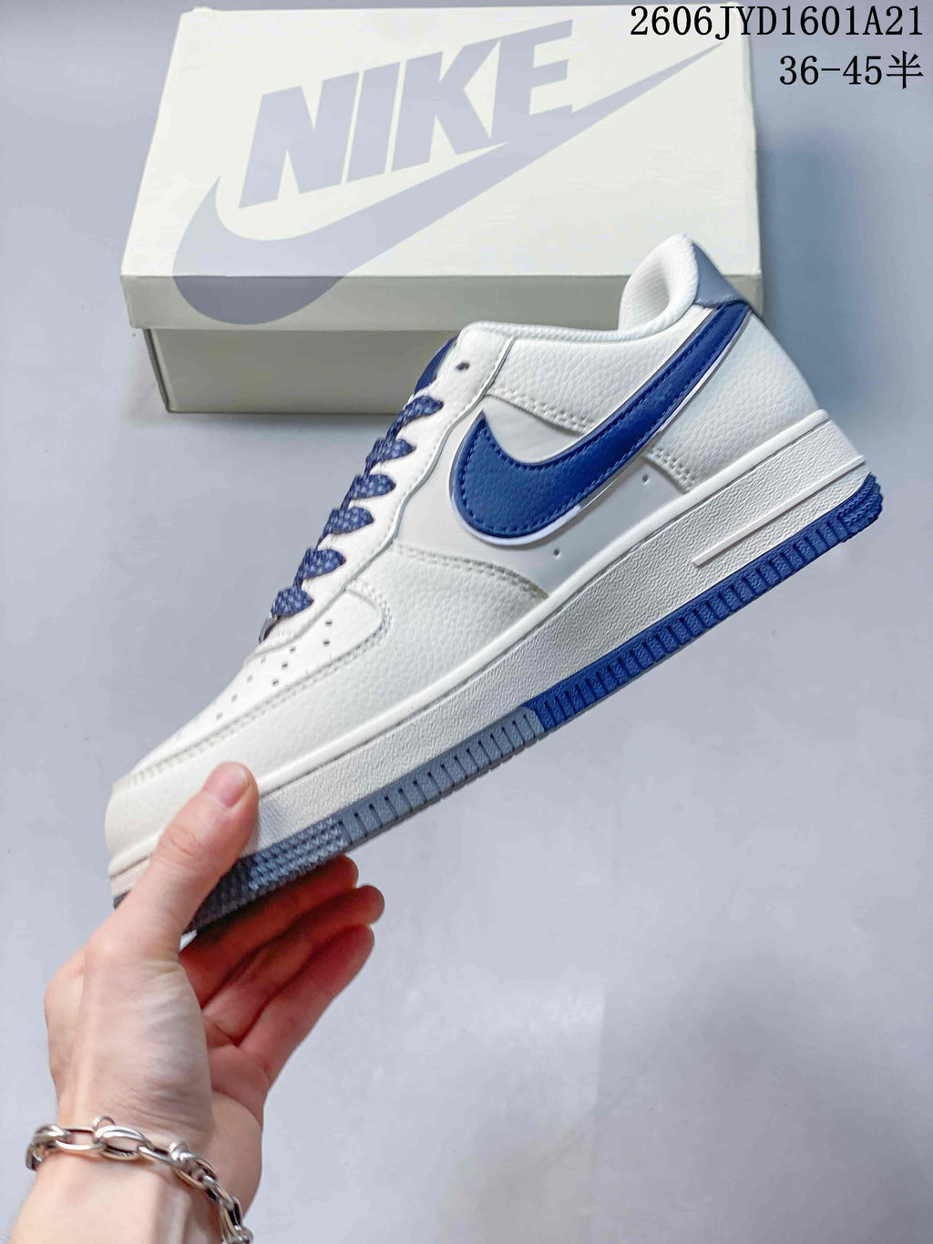 Side view showing the blue Swoosh and white upper