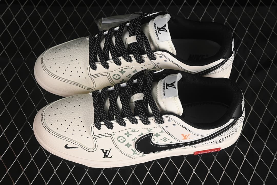 Overhead view of a pair of cream low-top sneakers with black laces and patterned side panels.