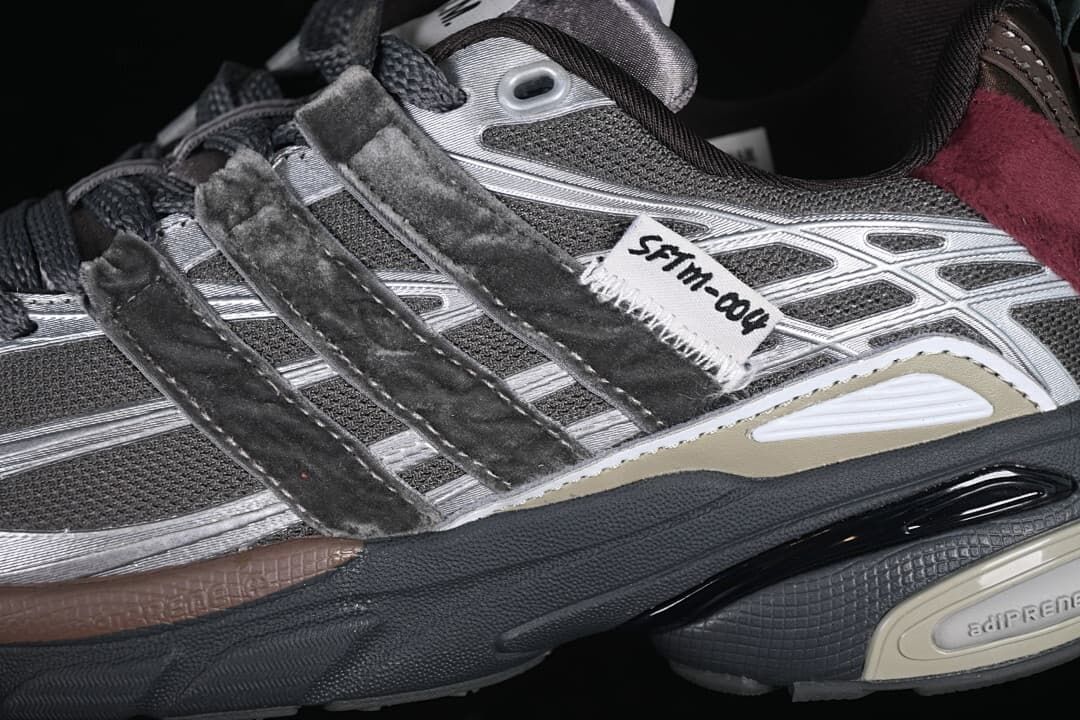 Close-up of the layered gray upper, three stripes, and visible adiPRENE marking.