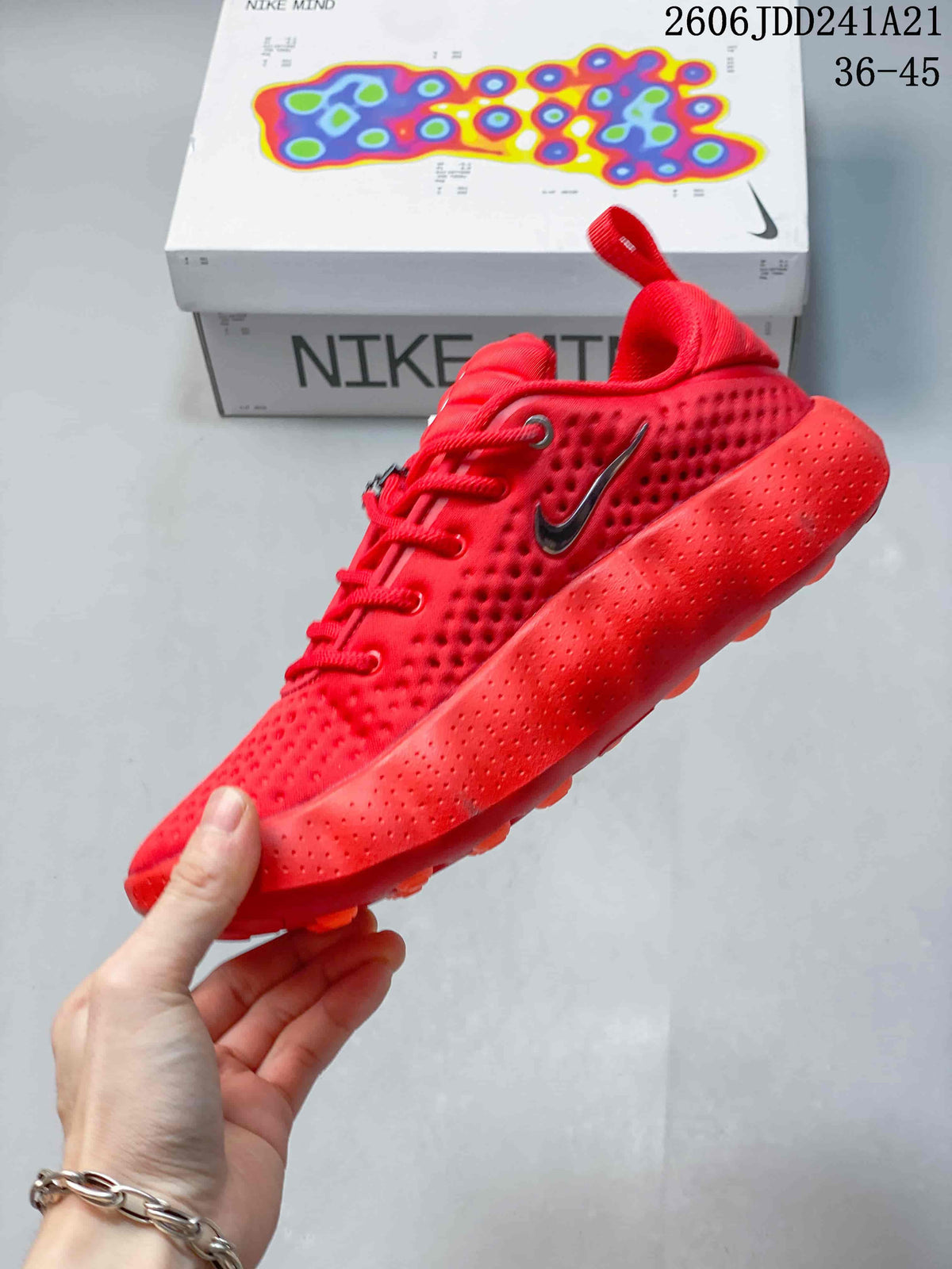 Side view of the red low-top shoe with textured upper and sculpted sole