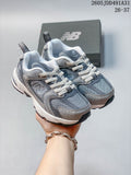 Pair of gray New Balance 530 kids' sneakers shown from the front and side