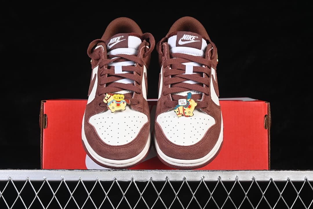 Front view of the pair with brown laces and decorative horse-themed charms