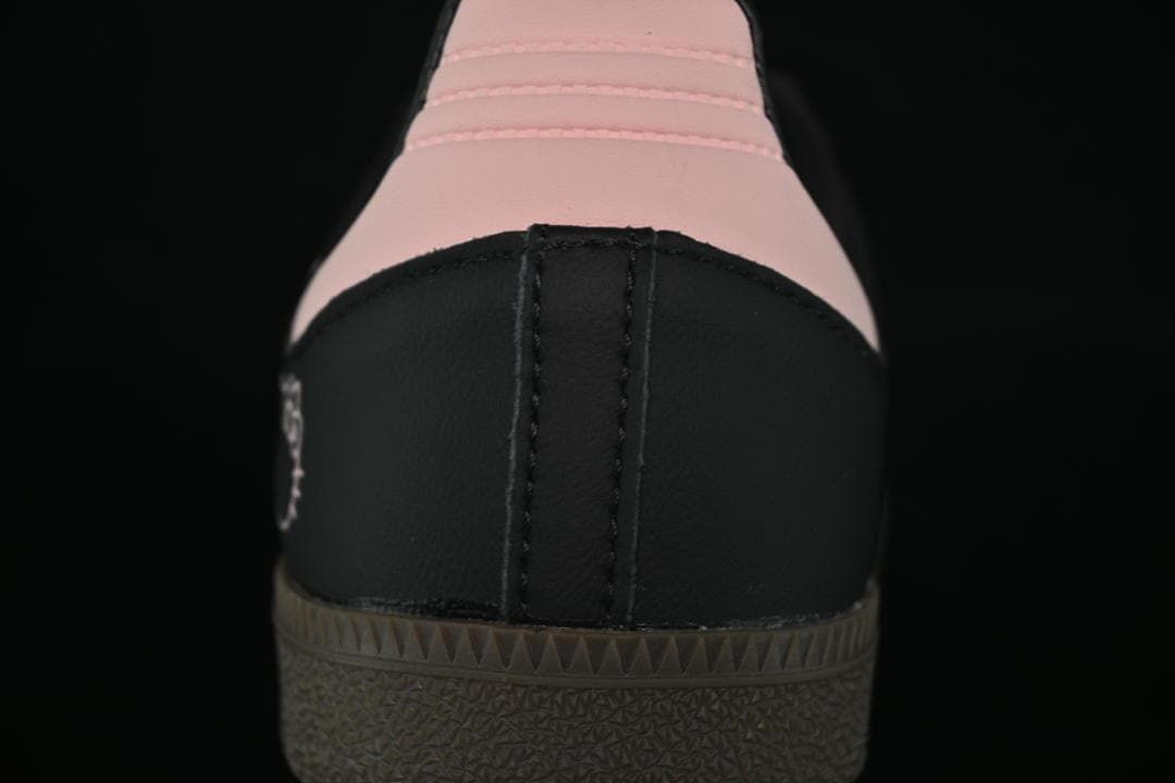 Rear view showing pink heel panels and dark outsole