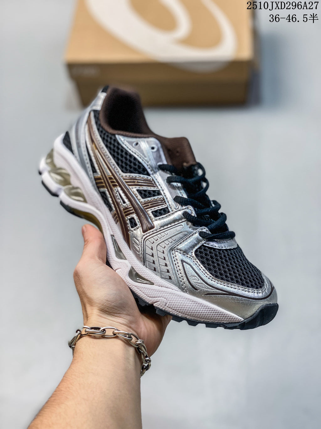Silver and black mesh sneaker with a metallic-look layered upper, held in hand.