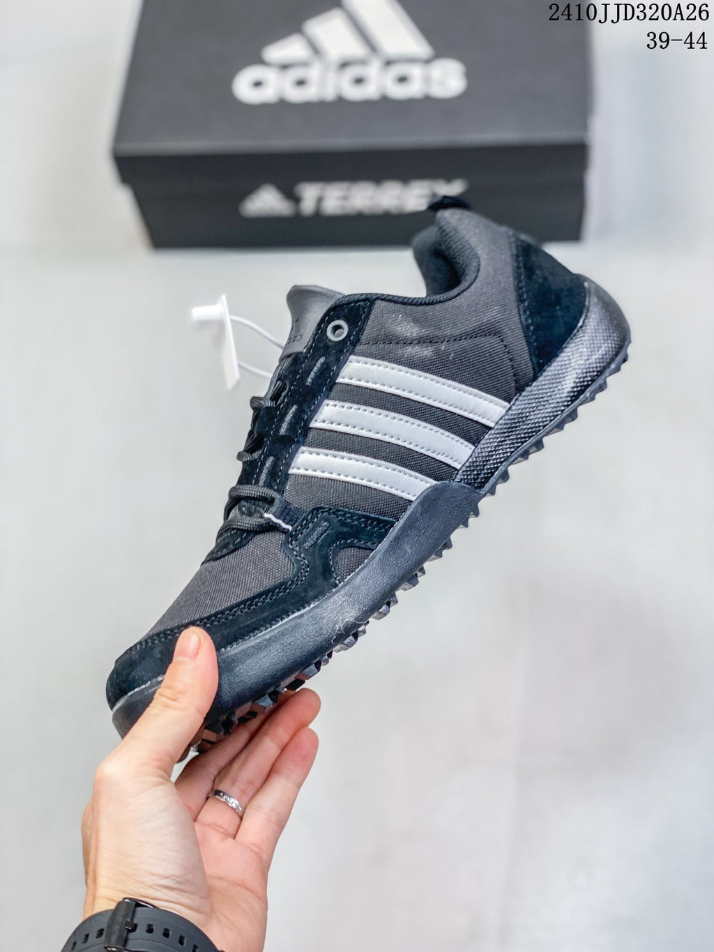 Side view of a charcoal adidas Daroga Plus shoe with contrasting stripes and a lugged sole; image overlay reads 39–44.
