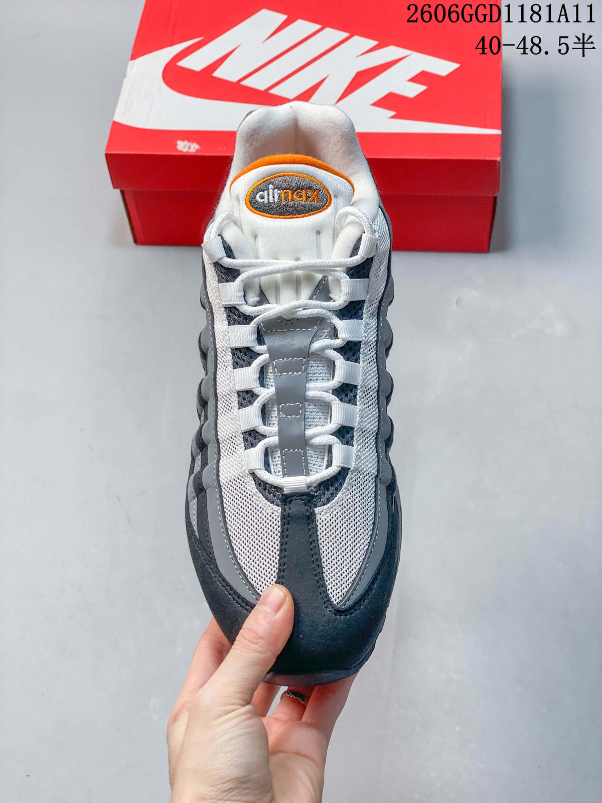 Top view of a Nike Air Max 95 OG sneaker showing white laces and layered gray panels