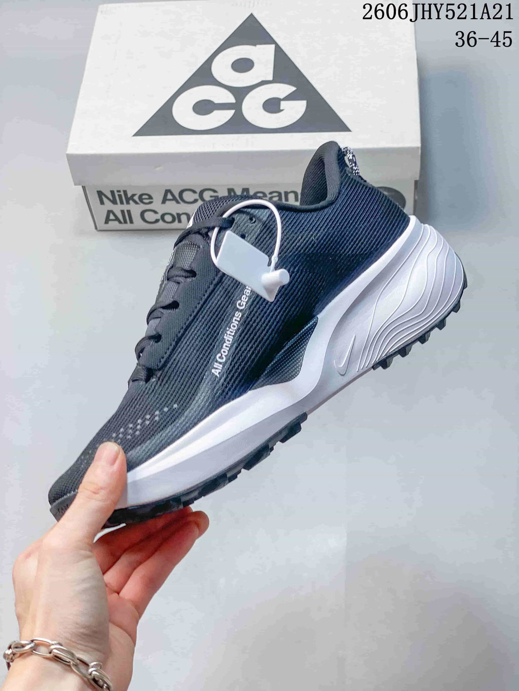 Side view of a dark gray Nike ACG Etcon 10 shoe with a white midsole