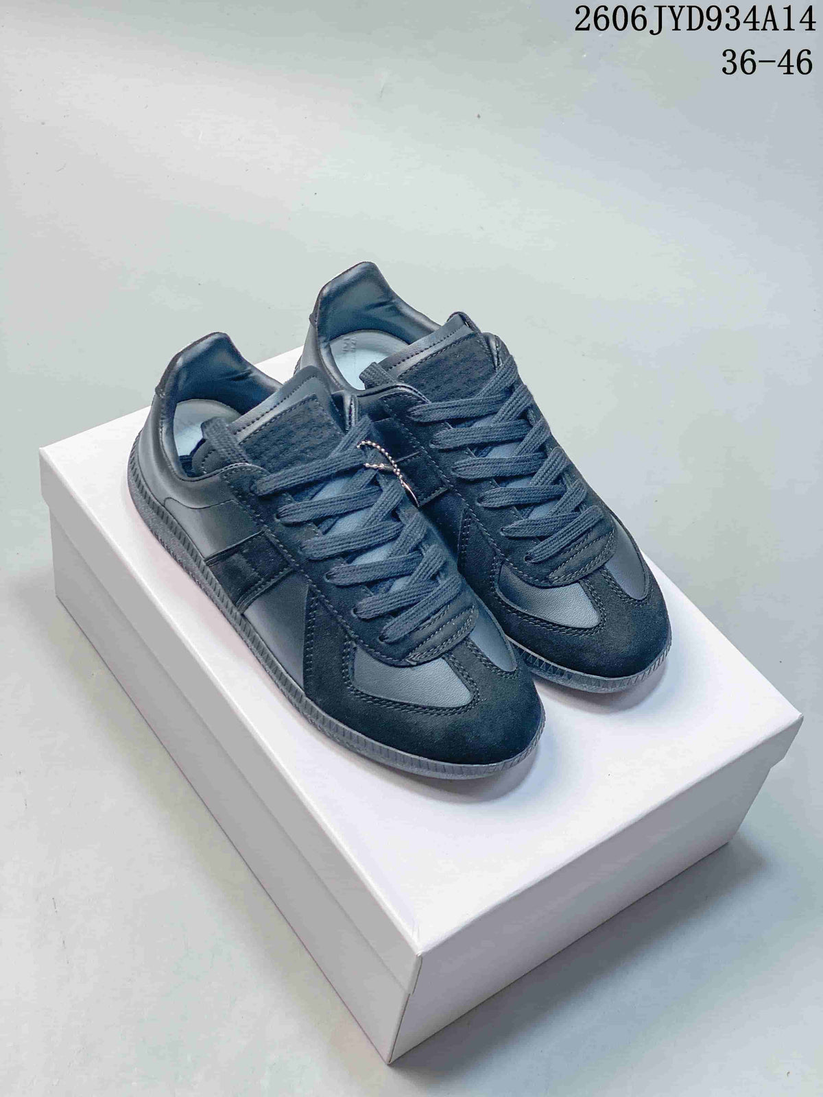Pair of dark navy Maison Margiela Replica low-top sneakers on a white box