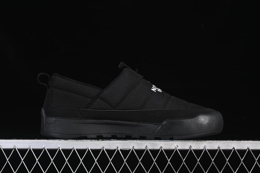 Side profile of a black slip-on shoe