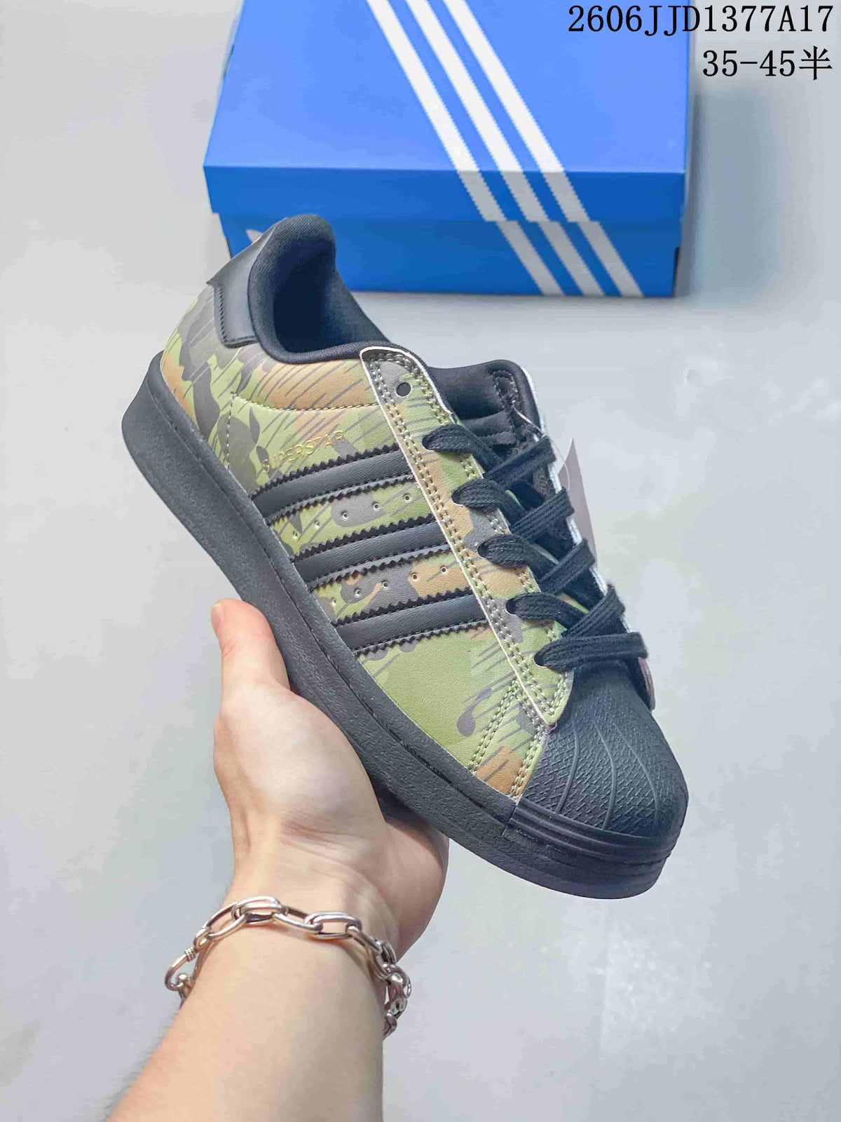 Angled side view highlighting the green camouflage pattern, dark stripes, and shell toe