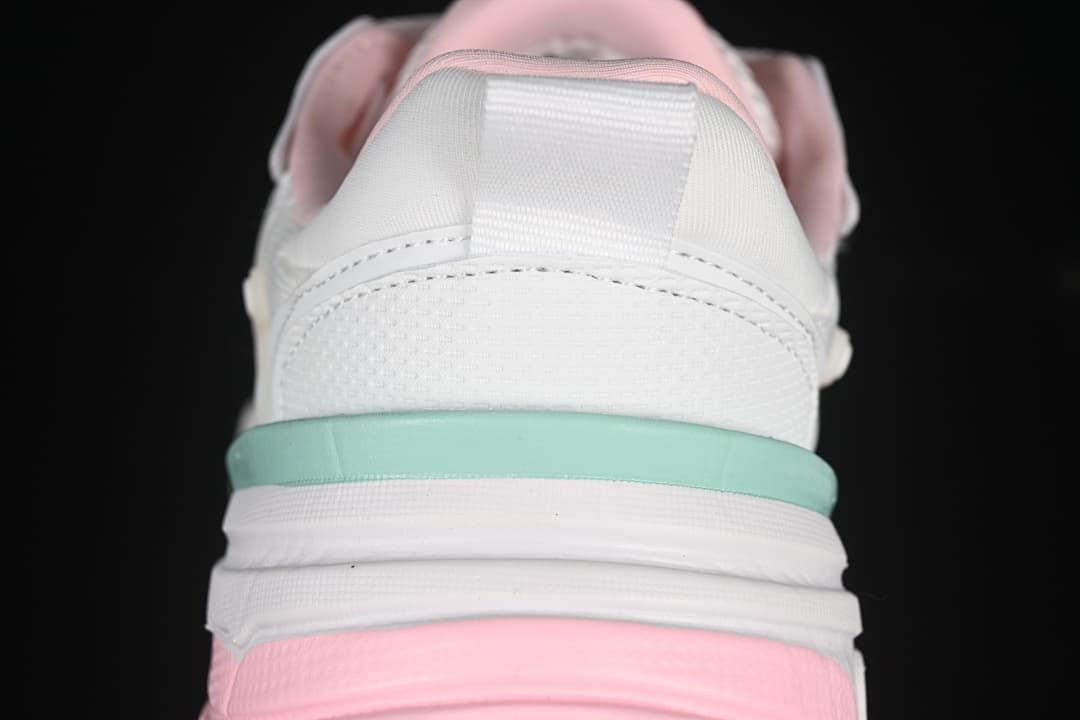 Rear view showing the heel pull tab and layered white, mint, and pink sole