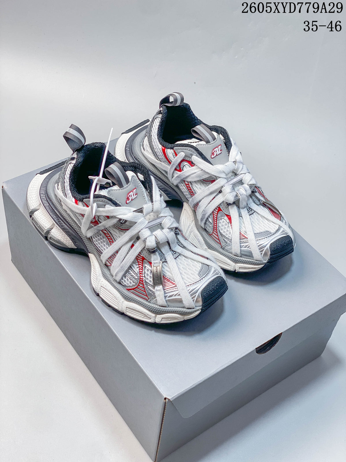Silver and white Balenciaga Phantom sneakers with red accents, photographed as a pair.