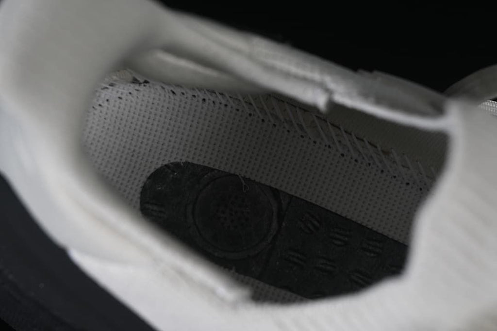 View inside the shoe showing the footbed and knit lining