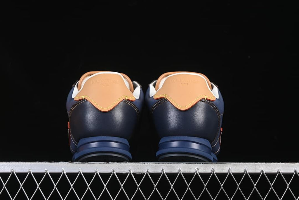 Rear view of the pair showing tan heel tabs and blue soles