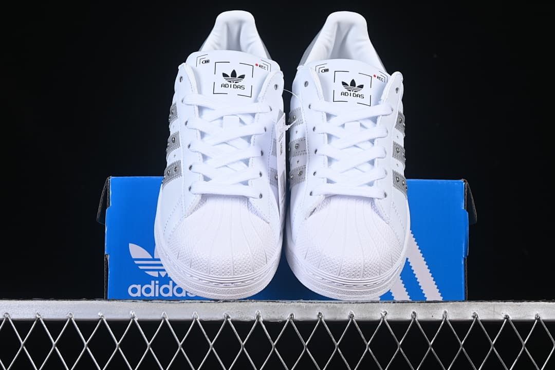 Front view of the pair showing shell toes, laces, and silver side accents