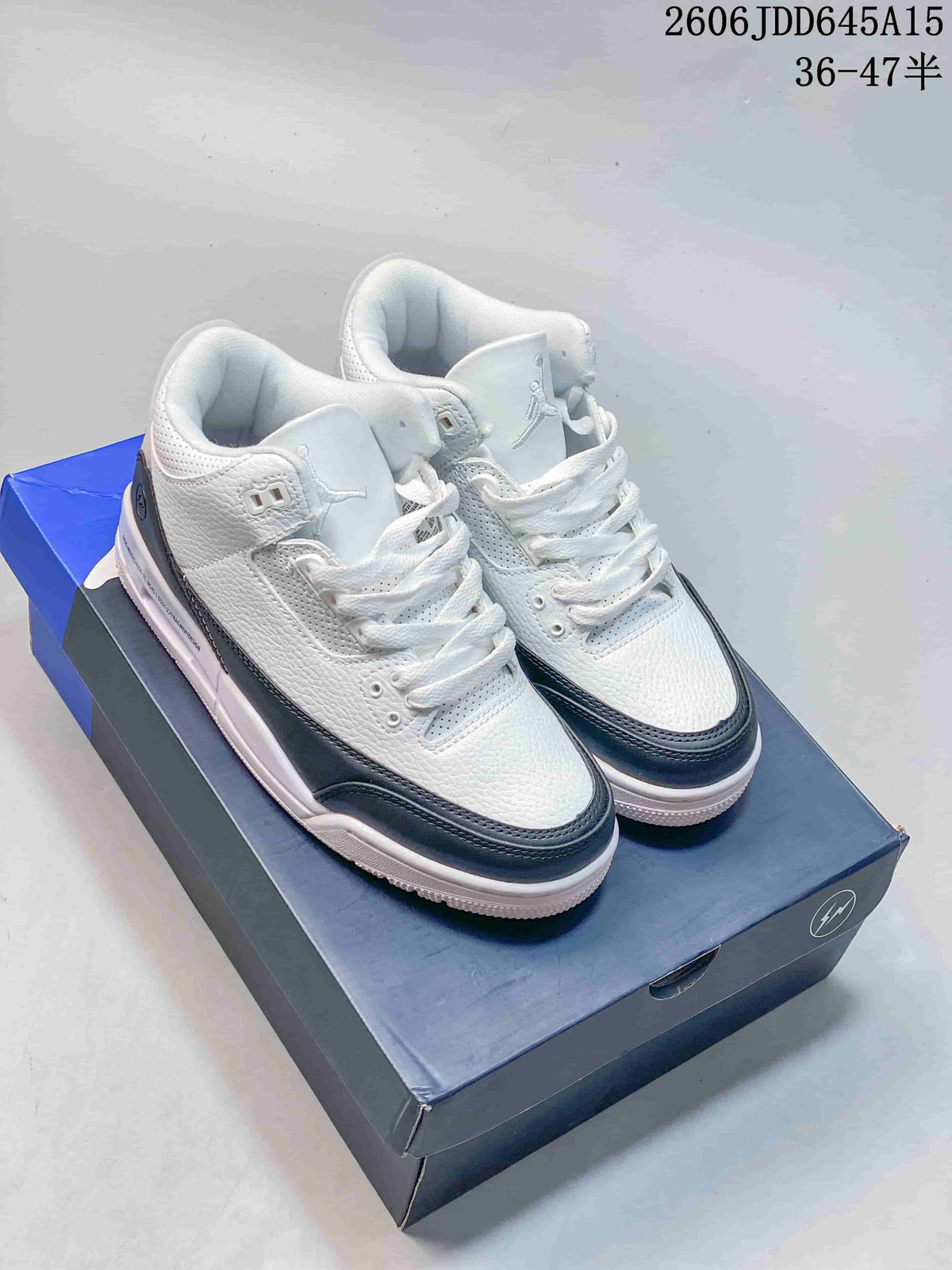Pair of white and dark-trim Air Jordan 3 Retro sneakers on a shoebox