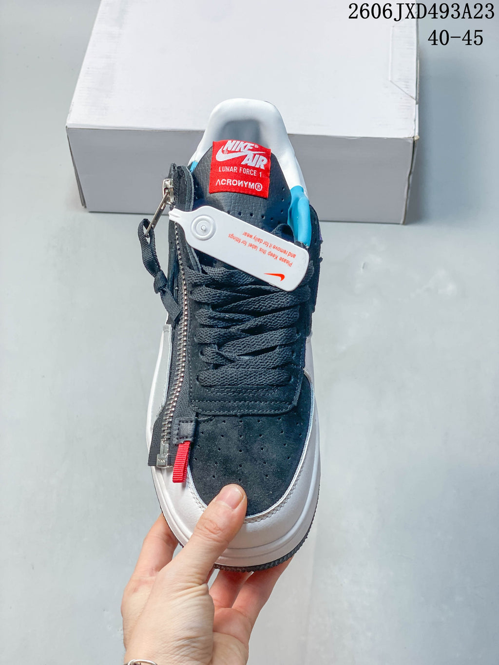 Front view showing the laces, perforated toe panel, and decorative side zipper