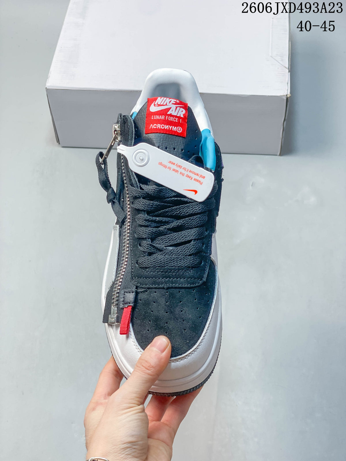 Front view showing the laces, perforated toe panel, and decorative side zipper