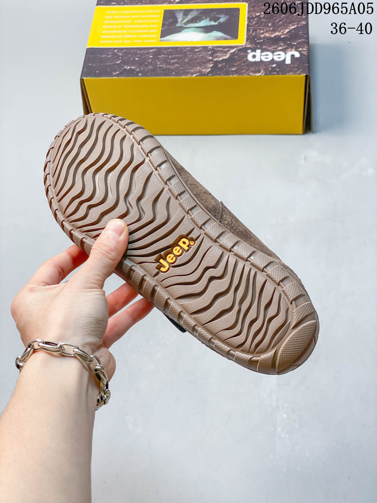 Close-up of the brown shoe's patterned outsole and Jeep mark