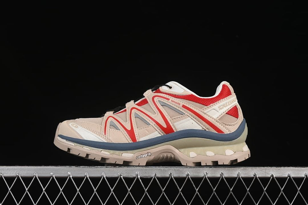 Side view of beige Salomon XT-Quest sneakers with red and slate-blue accents