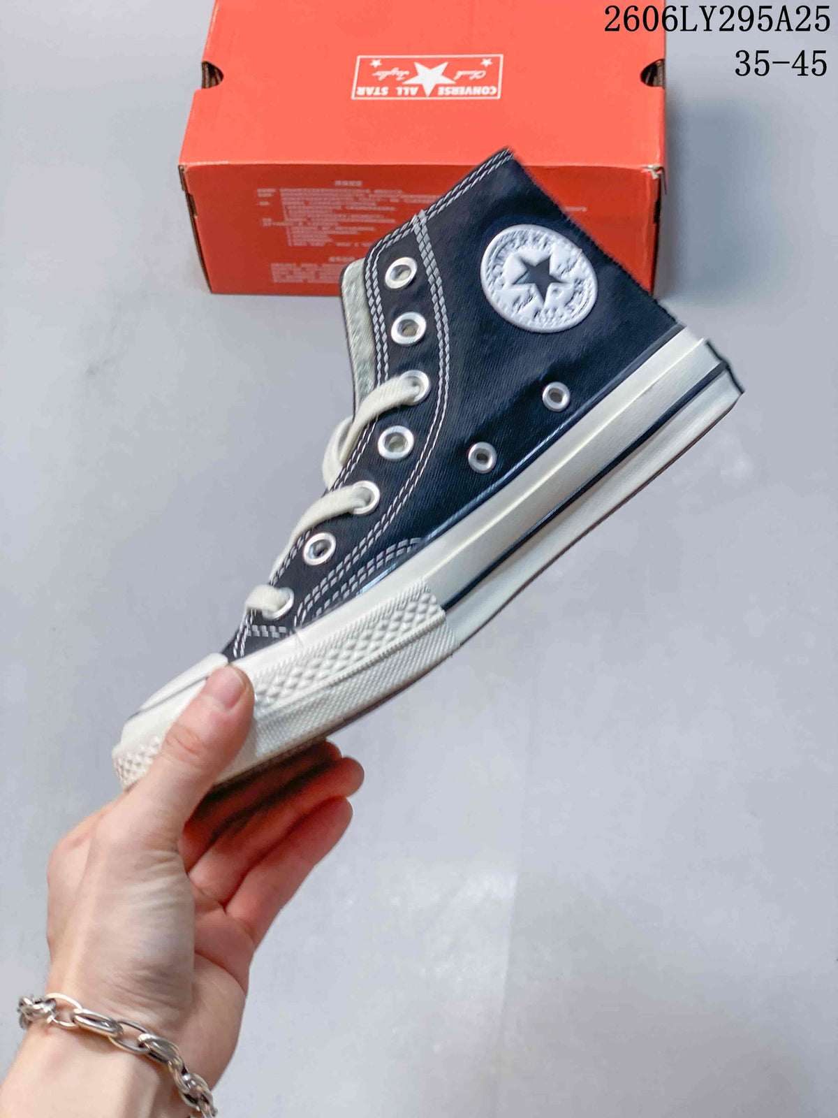 Side view of a navy Converse Chuck Taylor All Star high-top sneaker