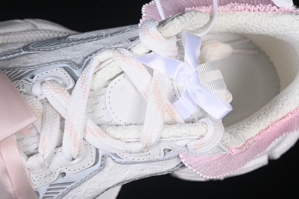 Top-down detail of the laces, tongue, and decorative ribbon accents.