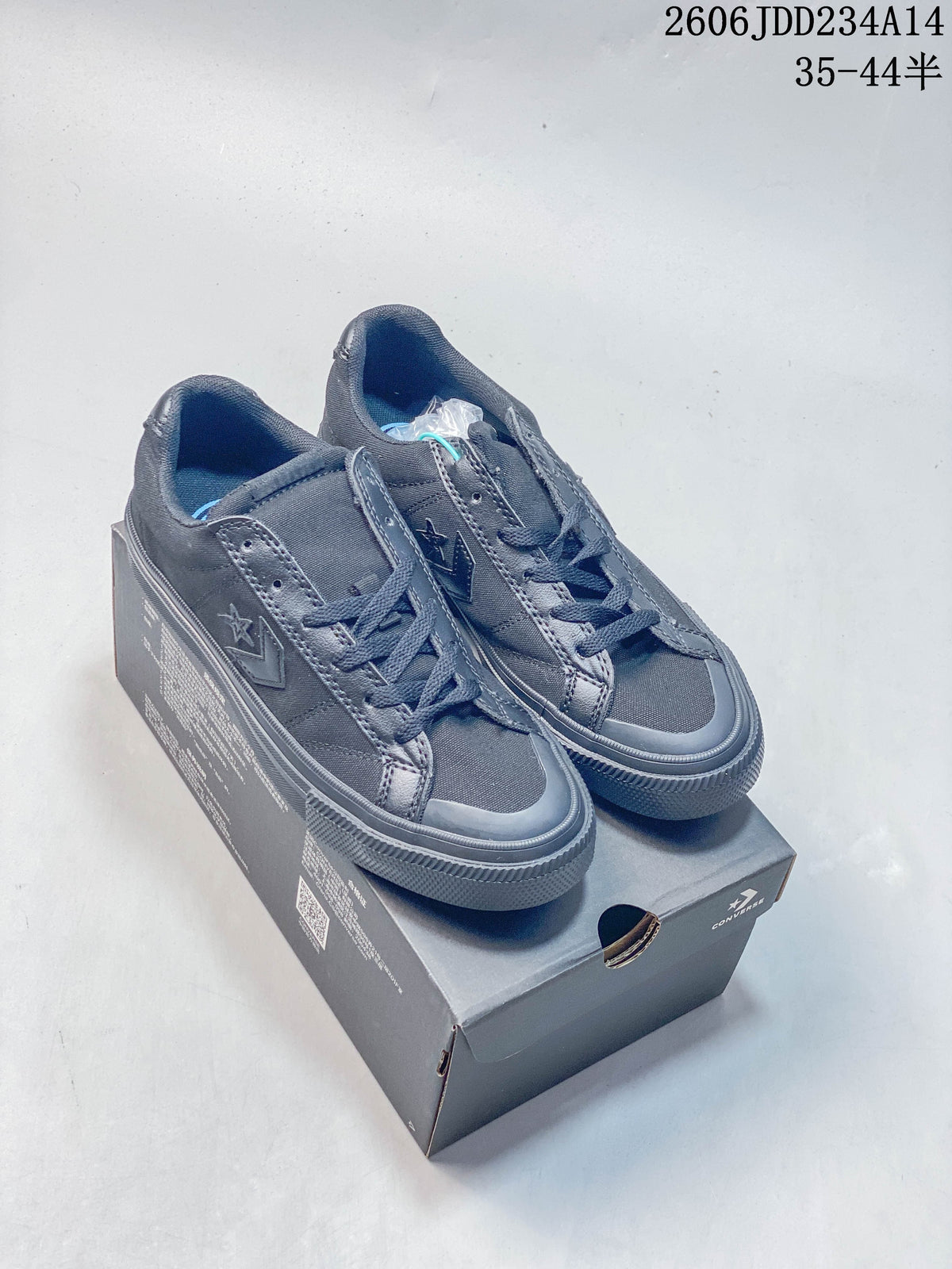 Pair of charcoal Converse low-top lace-up sneakers displayed on a shoebox