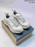 Pair of light gray The North Face Fastpack low-cut hiking shoes with pale yellow outsoles, displayed on a shoe box.